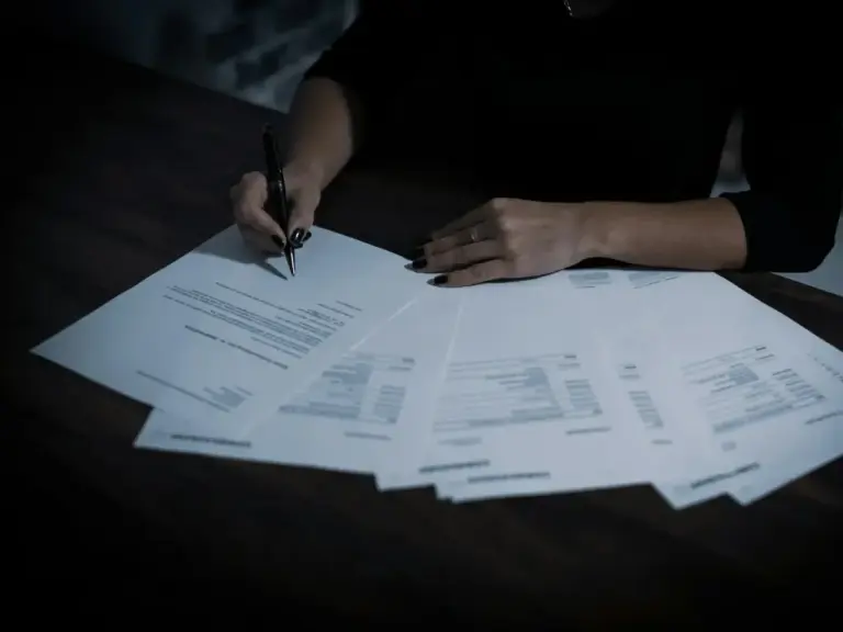 Advisor reviewing signed agreements at a desk
