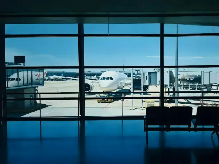 Aircraft at an airport gate seen through the terminal window