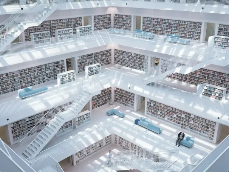 Central atrium of a modern library with white tiered shelving