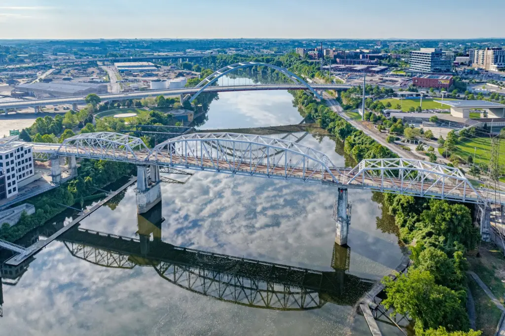 Aerial view of the Cumberland River and a bridge with downtown Nashville