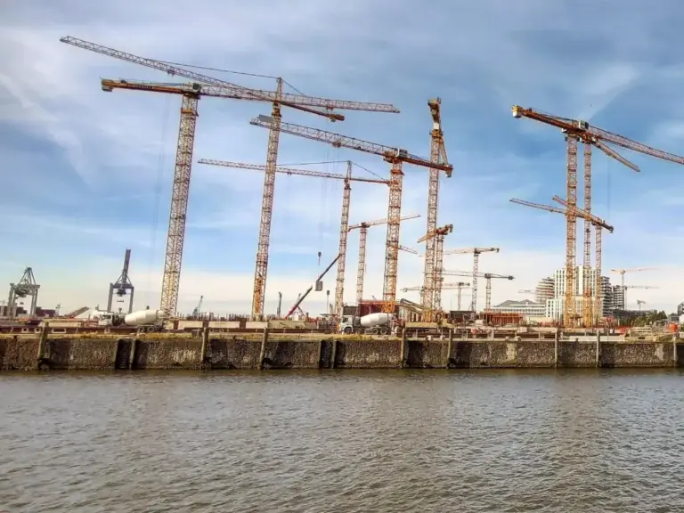 Tower cranes over a waterfront development site