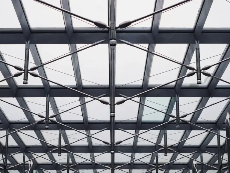 Steel roof structure seen from below inside a building under construction