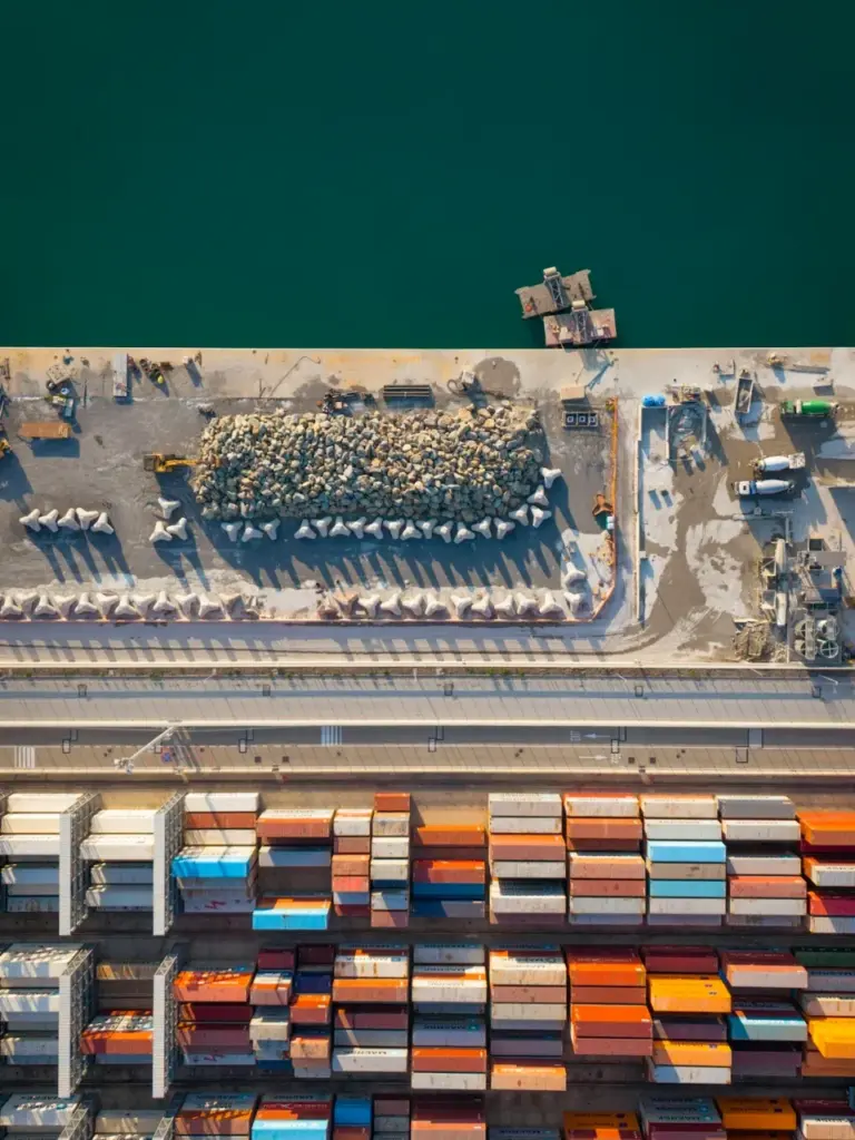 Aerial view of a container port with stacked cargo containers